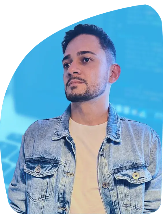 Blurred blue background with a photo of the programmer wearing a denim jacket, white shirt and short beard, black hair